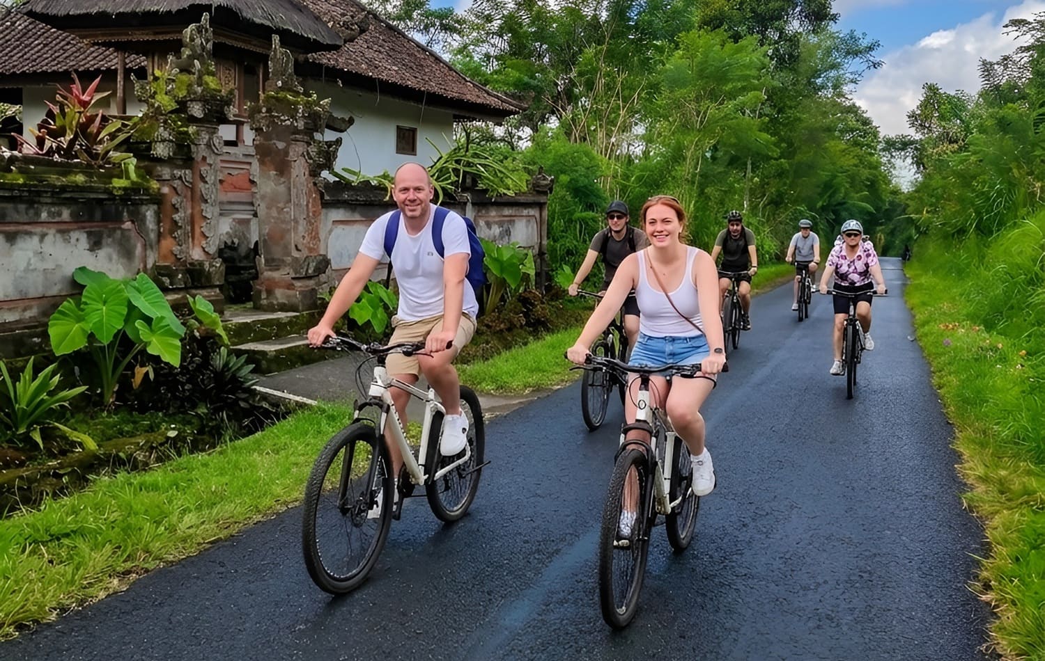 Group of people ride bike in downhill kintamani village