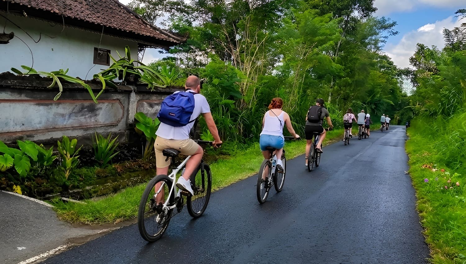 Group of people ride bike in downhill kintamani village
